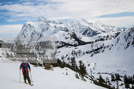 Young male skier moving along mountainside, Mount Baker, Washington, USA