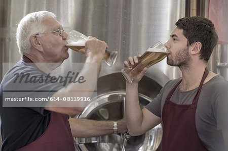 Two brewers drinking beer in the brewery