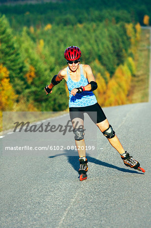 Woman rollerblading on country road