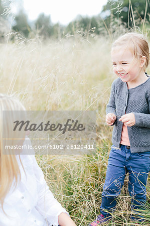 Mother with girl on meadow