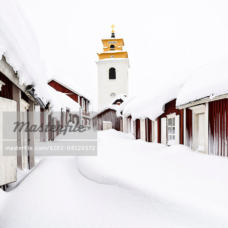 Wooden buildings covered in snow