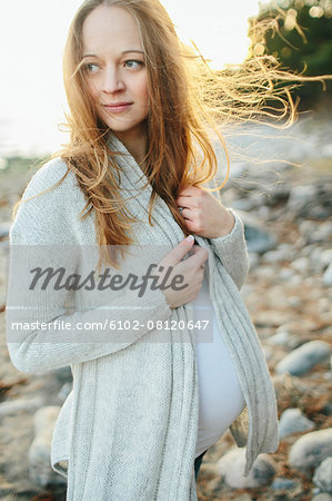 Young pregnant woman looking away