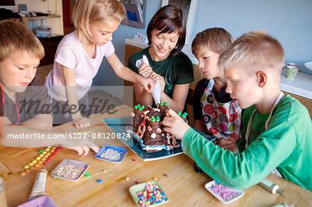 Children decorating cake