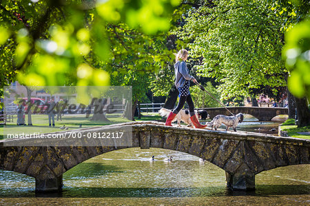 Stone, arch bridge crossing River Windrush, Bourton-on-the-Water, Gloucestershire, The Cotswolds, England, United Kingdom