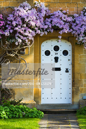 Close-up of doorway with flowering vine, Broadway, Worcestershire, The Cotswolds, England, United Kingdom