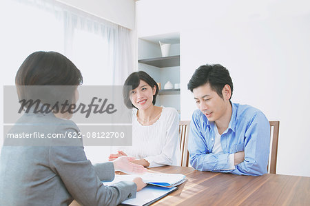 Young Japanese couple consulting with financial planner
