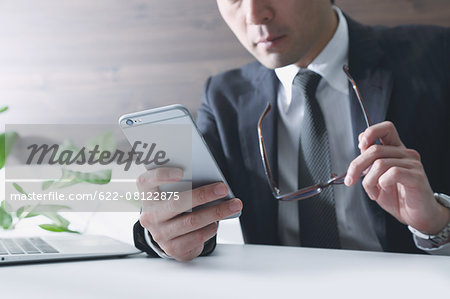 Japanese businessman working with large display smartphone