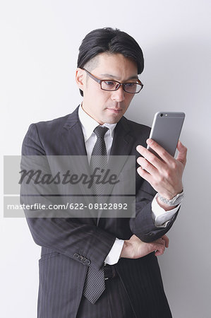 Japanese businessman working with large display smartphone