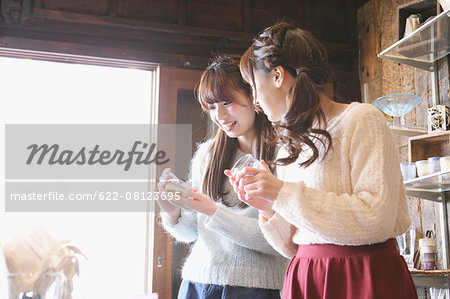Young Japanese women enjoying visit to glass workshop in Kawagoe, Japan