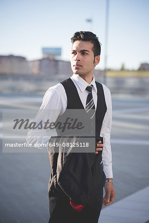 Young businessman carrying jacket Young businessman carrying jacket