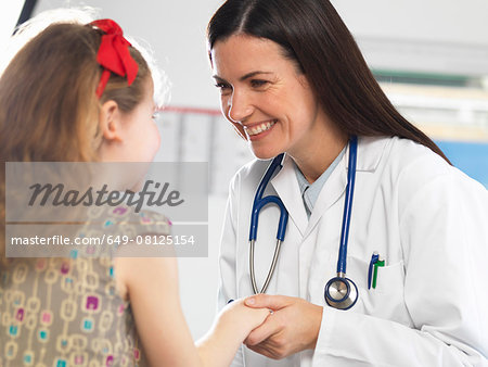 Doctor bonding with young girl during consultation