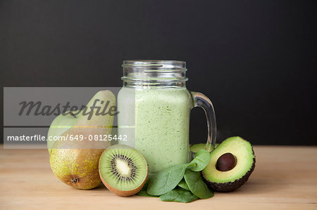 Still life of fresh kiwi, pear and avocado smoothie