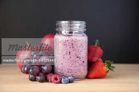 Still life of fresh grape, apple and berry smoothie