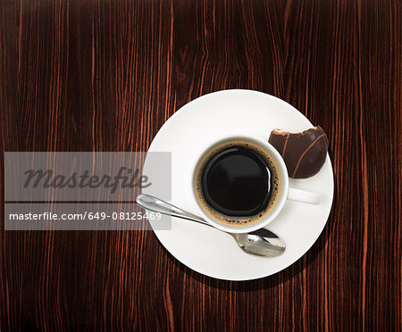 Overhead view of a black coffee on wooden table Overhead view of a black coffee on wooden table
