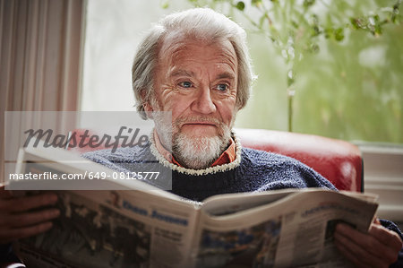 Senior man reading newspaper