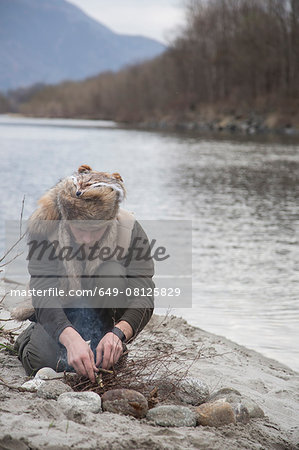 Mid adult man making campfire