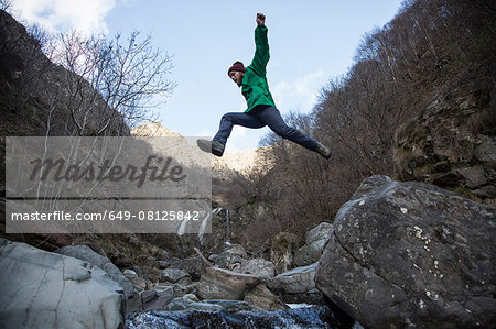 Man jumping over Toce River, Premosello, Verbania, Piedmonte, Italy
