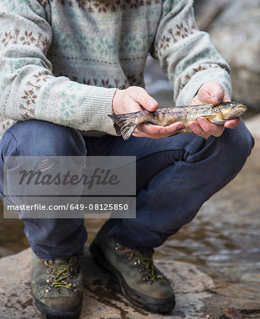 Man holding freshly caught fish