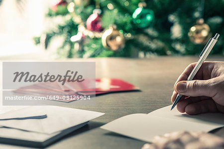 Person writing christmas cards