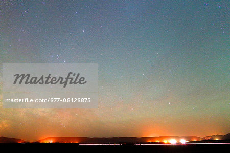 Morocco. Draa Valley. Zagora region. Starry sky (region of Sagittarius and Centaurus) and Milky Way over the desert and Moroccan villages.