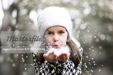 Girl holding snow in her hands