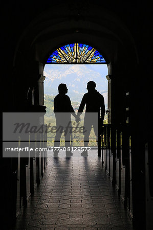 Silhouette of a gay couple to the output of church. France.