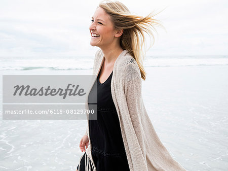 Portrait of a smiling young woman on a beach.