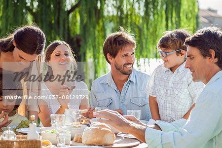 Family enjoying breakfast together outdoors Family enjoying breakfast together outdoors