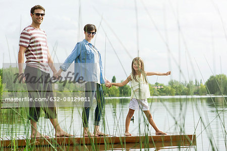 Family holding hands on dock, portrait