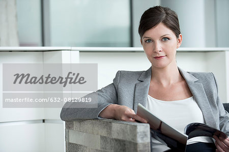 Woman in waiting room looking at magazine