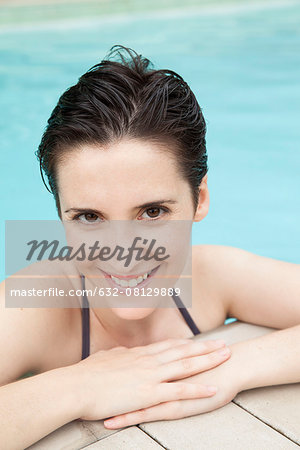 Woman relaxing in pool, portrait