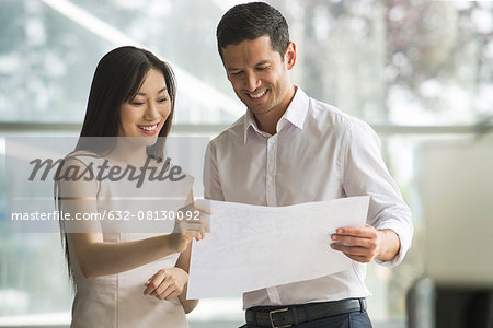 Business professionals reviewing document together