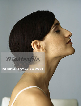 Woman with chignon, eyes closed, profile