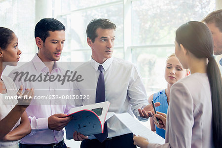 Business professionals collaborating in high pressure setting Business professionals collaborating in high pressure setting