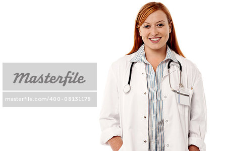 Smiling female doctor with hands on coat pockets
