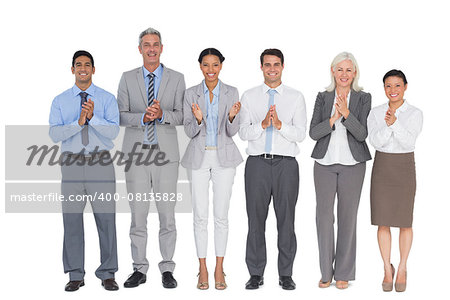 Smiling business people applauding on white background