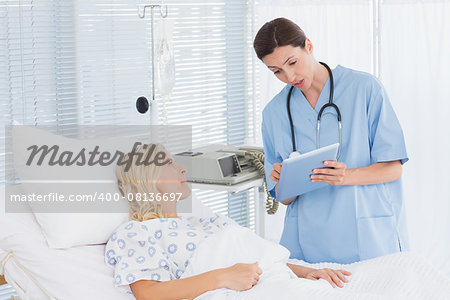 Doctor taking care of patient in hospital room