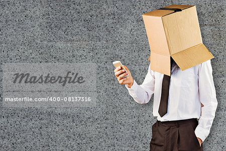 Anonymous businessman with his smartphone against grey background