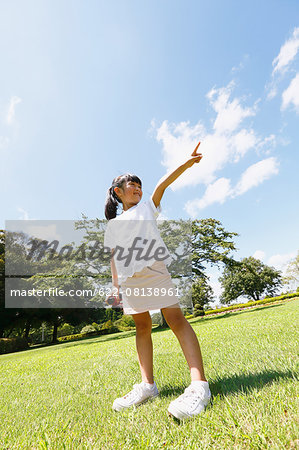 Japanese young girl with binoculars in a city park