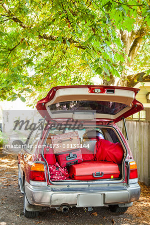 Trunk of a car packed with luggage
