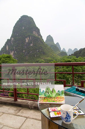 Watercolor materials on a patio overlooking the Karst  mountains, Yangshuo, China