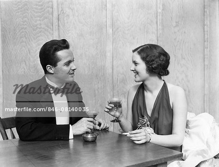 1930s 1940s COUPLE DRINKING TOASTING CLUB TABLE SMOKING CIGARETTE MAN WOMAN MEN WOMEN COUPLES TUXEDO MARTINI RESTAURANT PARTY 1930s 1940s COUPLE DRINKING TOASTING CLUB TABLE SMOKING CIGARETTE MAN WOMAN MEN WOMEN COUPLES TUXEDO MARTINI RESTAURANT PARTY