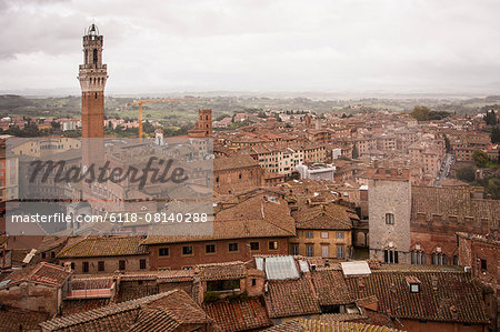 High angle view across the city of Siena with the Piazza del Campo and Torre del Mangia landmarks.