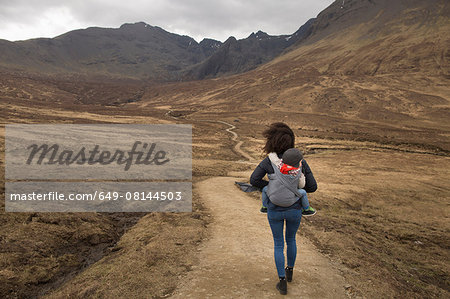 Mother carrying son in sling, Fairy Pools, near Glenbrittle, Isle of Skye, Hebrides, Scotland