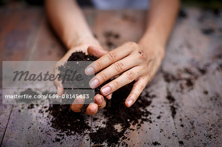 Cropped view of hands holding soil