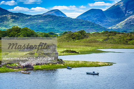 Scenic view with fisherman at Upper Lake, Killarney National Park, near the town of Killarney, County Kerry, Ireland