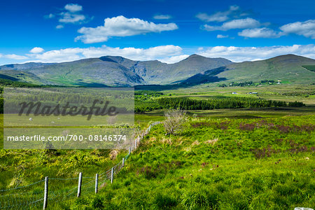 Scenic view of fields and mountains along the Ring of Kerry, County Kerry, Ireland Scenic view of fields and mountains along the Ring of Kerry, County Kerry, Ireland