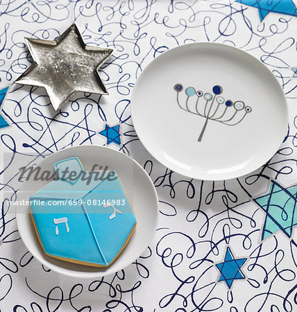 A start-shaped sliver dish, a plate and a a biscuit for Hanukkah A start-shaped sliver dish, a plate and a a biscuit for Hanukkah