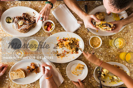 People having a breakfast of nachos, sandwiches and pancakes (USA)