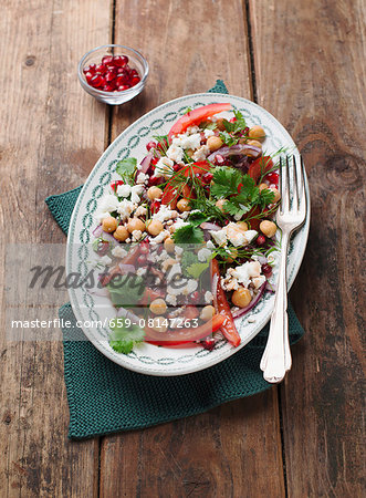 Chickpea salad with peppers, feta cheese and pomegranate seeds